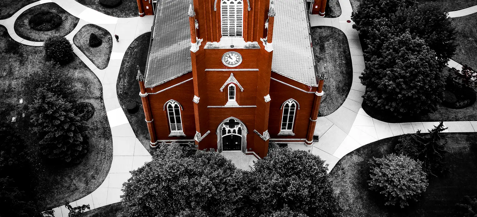 Aerial view of a red-brick church in downtown London, Ontario, with its grounds in black and white