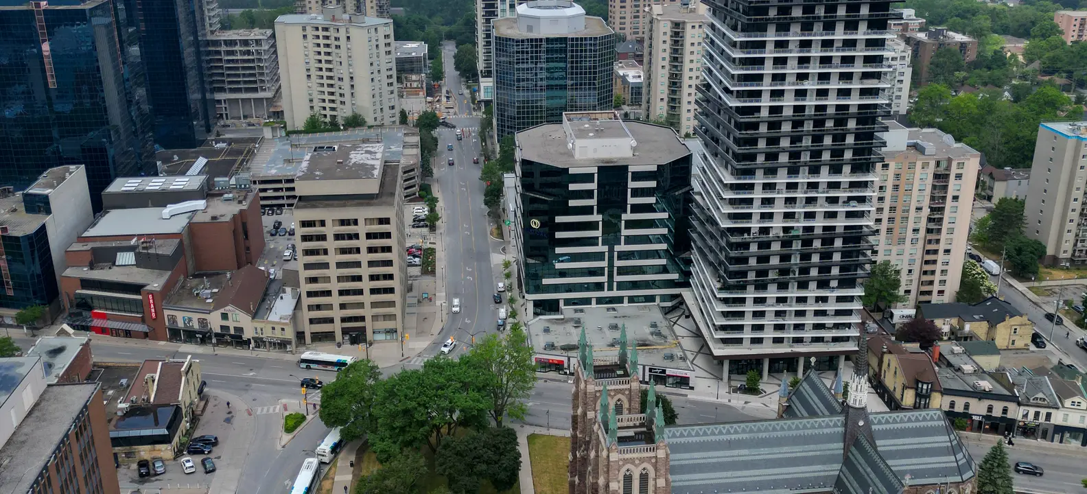 Aerial view of downtown London, Ontario's towers and a stone church, a short walk west of Old East Village